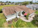 Lovely home featuring great curb appeal, complemented by mature palms and meticulous landscaping at 9253 Water Hazard Dr, Hudson, FL 34667