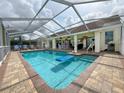 Screened-in pool and patio area perfect for relaxation and entertainment at 9253 Water Hazard Dr, Hudson, FL 34667