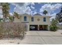 Charming two-story home with a two car garage, coastal landscaping and a driveway to the street at 9914 Alavista Dr, Gibsonton, FL 33534