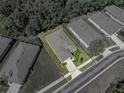 Drone's-eye view displays the home's full lot, neat landscaping and a surrounding of matched, similar houses at 12669 Eastpointe Dr, Dade City, FL 33525