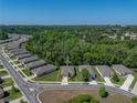 Aerial view of the home showcases its location within a peaceful neighborhood with mature trees and well-maintained streets at 12669 Eastpointe Dr, Dade City, FL 33525