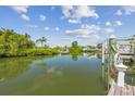 Picturesque waterway with clear, still water reflecting the lush vegetation and blue sky above at 1326 Apollo Beach S Blvd, Apollo Beach, FL 33572
