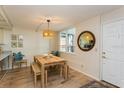 Bright dining area with a wood table, bench seating, wicker pendant light, and neutral colors at 17900 Gulf Blvd # 1B, Redington Shores, FL 33708