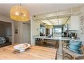 Dining area showcases a light fixture, seating, and connection to kitchen space at 17900 Gulf Blvd # 1B, Redington Shores, FL 33708