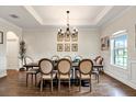 Bright dining room with wood floors, a decorative chandelier, and natural light from a window at 21028 Ski Way, Land O Lakes, FL 34638