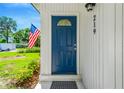 This property's blue front door with a decorative window offers a secure and stylish welcome at 219 80Th Ne Ave, St Petersburg, FL 33702