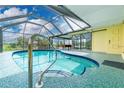 The enclosed pool offers a relaxing retreat with a screened enclosure and scenic water views at 2324 Hayworth Rd, Port Charlotte, FL 33952
