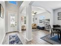 Inviting foyer with high ceilings, elegant arches, and views into the formal living and dining spaces at 3046 Donington Castle Ln, Land O Lakes, FL 34638