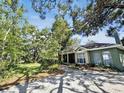 Charming one-story home with mature trees and a paved driveway at 3603 E Sterling Cir, Tampa, FL 33629