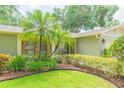 Exterior showcasing the lush front yard, stone accents, and well-maintained landscaping at 3714 Village Estates Pl, Tampa, FL 33618