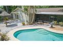 Backyard pool with a tanning deck, adjacent patio, and gazebo, perfect for outdoor enjoyment at 3714 Village Estates Pl, Tampa, FL 33618