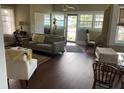 Inviting living room featuring an open door, and multiple windows at 41 W Boyer St, Tarpon Springs, FL 34689