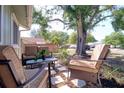 Relaxing front porch with comfortable seating, perfect for enjoying a quiet afternoon outdoors at 506 Summerwood Ct, Tarpon Springs, FL 34689