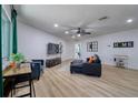 Spacious living room featuring new flooring, neutral paint, a ceiling fan, and a modern aesthetic at 506 Summerwood Ct, Tarpon Springs, FL 34689