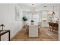 Elegant dining area with a chandelier, neutral tones, and an open view to the kitchen at 5351 Bridge St # 9, Tampa, FL 33611