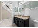 Bathroom featuring granite counters, dark cabinetry and white paneling at 7699 Windchase Way, Wesley Chapel, FL 33545