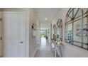 Bright hallway featuring decorative mirrors and neutral paint at 7763 Wheat Stone Dr, Zephyrhills, FL 33540