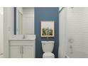 Stylish bathroom featuring white subway tile, modern fixtures, and a vanity with a granite countertop at 7796 Painted Sky Pl, Land O Lakes, FL 34637