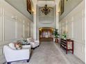 Elegant lobby with tile flooring, wainscotting, seating, and decorative lighting at 7901 Seminole Blvd # 1103, Seminole, FL 33772