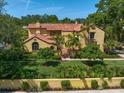 Lush aerial view of a home featuring vibrant landscaping, a terracotta tile roof, and a manicured lawn at 843 17Th N Ave, St Petersburg, FL 33704