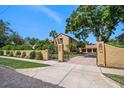 Beautiful exterior of a home with a brick driveway, secure gate, and well-maintained landscaping at 843 17Th N Ave, St Petersburg, FL 33704