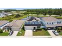 Aerial view of a well-situated two-story home featuring solar panels and beautiful landscaping at 8595 Prairie Creek Dr, New Port Richey, FL 34655