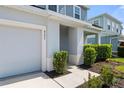 Close-up of the front entrance with a covered porch and manicured bushes at 8595 Prairie Creek Dr, New Port Richey, FL 34655