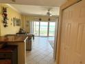 Bright living room with tile floors, ceiling fan, and large sliding glass doors with beach views at 880 Mandalay Ave # N109, Clearwater Beach, FL 33767