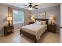 Well-lit bedroom with a queen-size bed, neutral decor, and stylish side tables with lamps at 9516 Newdale Way # 101, Riverview, FL 33578
