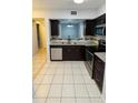 Modern kitchen features stainless steel appliances, dark wood cabinets, and granite countertops at 9516 Newdale Way # 101, Riverview, FL 33578