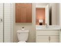 Modern bathroom features a white vanity, matching toilet, shower and accent art at 9657 Runaway Breeze Dr, Land O Lakes, FL 34637