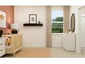 Well-lit Bedroom with a crib, neutral tones, modern decor and a large window at 9657 Runaway Breeze Dr, Land O Lakes, FL 34637