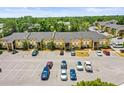 Exterior view of a multi-Gathering residence with ample parking spaces and surrounding greenery at 10100 Sailwinds N Blvd # 105, Largo, FL 33773
