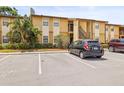 Exterior view of a multi-Gathering residence with ample parking and well-maintained landscaping at 10100 Sailwinds N Blvd # 105, Largo, FL 33773