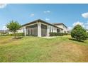 Spacious backyard with screened lanai and green grass, perfect for outdoor enjoyment at 10420 Echo Dock Loop, San Antonio, FL 33576