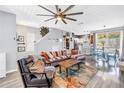 Open-concept living room with stylish furnishings, staircase, and seamless flow to the dining area and kitchen at 12323 Country White Cir, Tampa, FL 33635