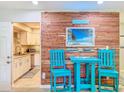 Cozy dining area showcases a decorative wood wall and stylish blue table set at 149 Sky Loch Dr E, Dunedin, FL 34698