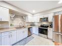 Bright, modern kitchen with stainless steel appliances and sleek white cabinetry at 149 Sky Loch Dr E, Dunedin, FL 34698