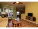 Comfortable living room area open to dining space with hardwood floors and sunny view at 1910 E Palm Ave # 10209, Tampa, FL 33605