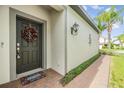 Stylish front door adorned with a wreath, creating a warm and inviting entrance at 19400 Roseate Dr, Lutz, FL 33558