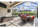 Relaxing screened-in patio with comfortable seating, perfect for outdoor entertaining at 19400 Roseate Dr, Lutz, FL 33558