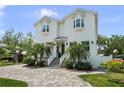 Charming two-story home featuring manicured lawn, brick driveway and classic curb appeal at 2303 S Occident St, Tampa, FL 33629