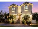 Beautifully lit exterior of two-story home with brick driveway, landscaping, and curb appeal at 2303 S Occident St, Tampa, FL 33629
