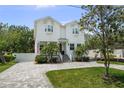 Two-story home showcasing a well-maintained lawn and traditional architecture at 2303 S Occident St, Tampa, FL 33629