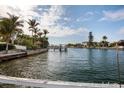 Scenic waterfront view of a serene canal lined with lush greenery and charming waterfront homes at 2487 W Bay Isle Se Dr, St Petersburg, FL 33705