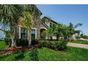 Attractive home featuring stone accents, verdant landscaping, and a well-maintained lawn at 2653 Longleaf Pine Pt, New Port Richey, FL 34655