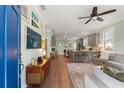 Open-concept living room and kitchen featuring hardwood floors and stylish decor at 3008 N 13Th St, Tampa, FL 33605