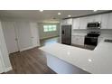 Bright kitchen featuring white cabinets, stainless steel appliances, and quartz countertops at 3188 Lake Saxon Dr, Land O Lakes, FL 34639