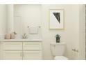 Bathroom featuring a modern vanity with a granite countertop, contemporary fixtures, and stylish decor at 32062 Griffin Sands Ln, San Antonio, FL 33576