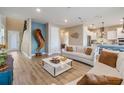 Bright living room featuring stylish decor, hardwood floors, and an open layout at 3303 Monroe Meadows Dr, Odessa, FL 33556